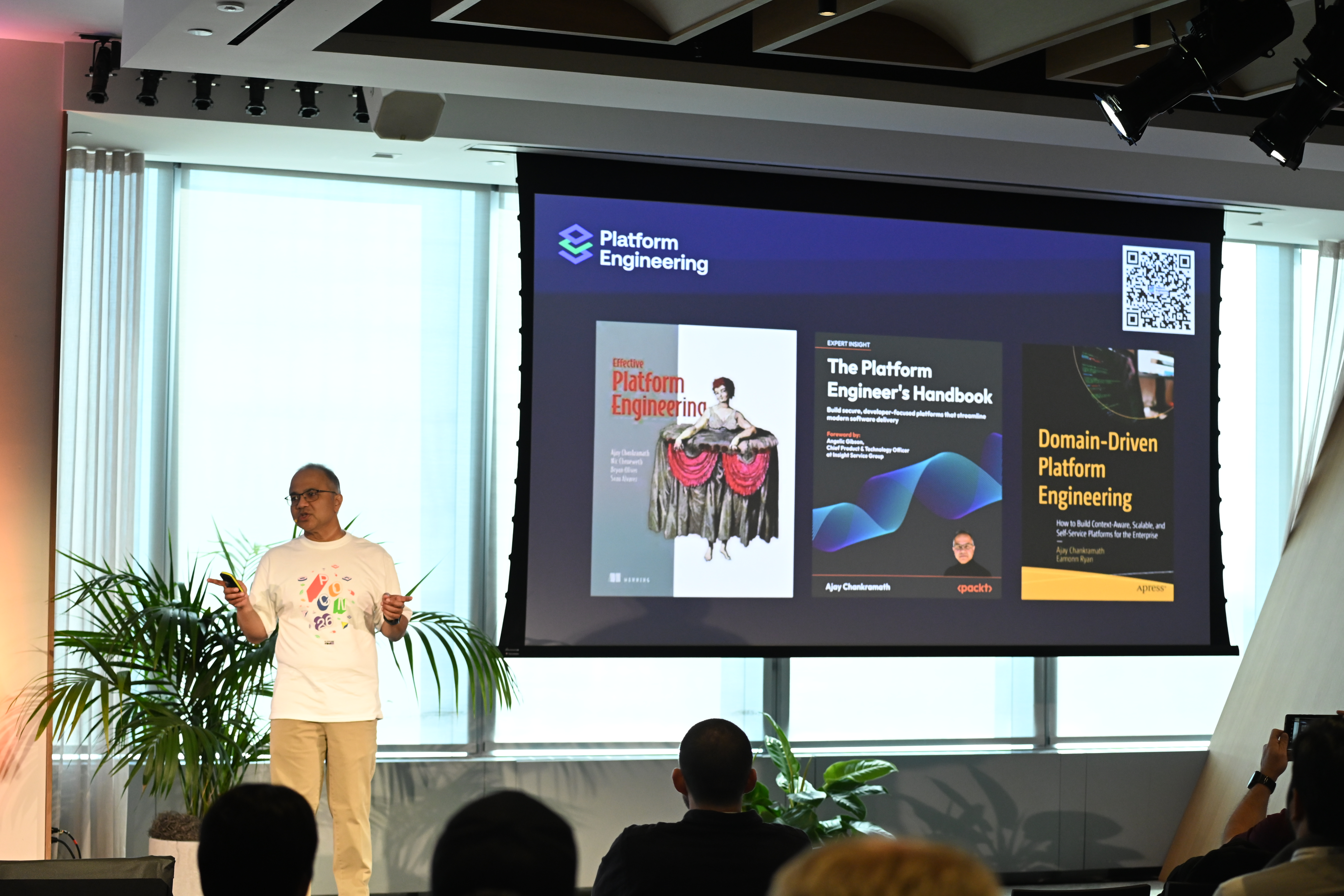 Ajay presenting PEC-authored books on stage at PlatformCon