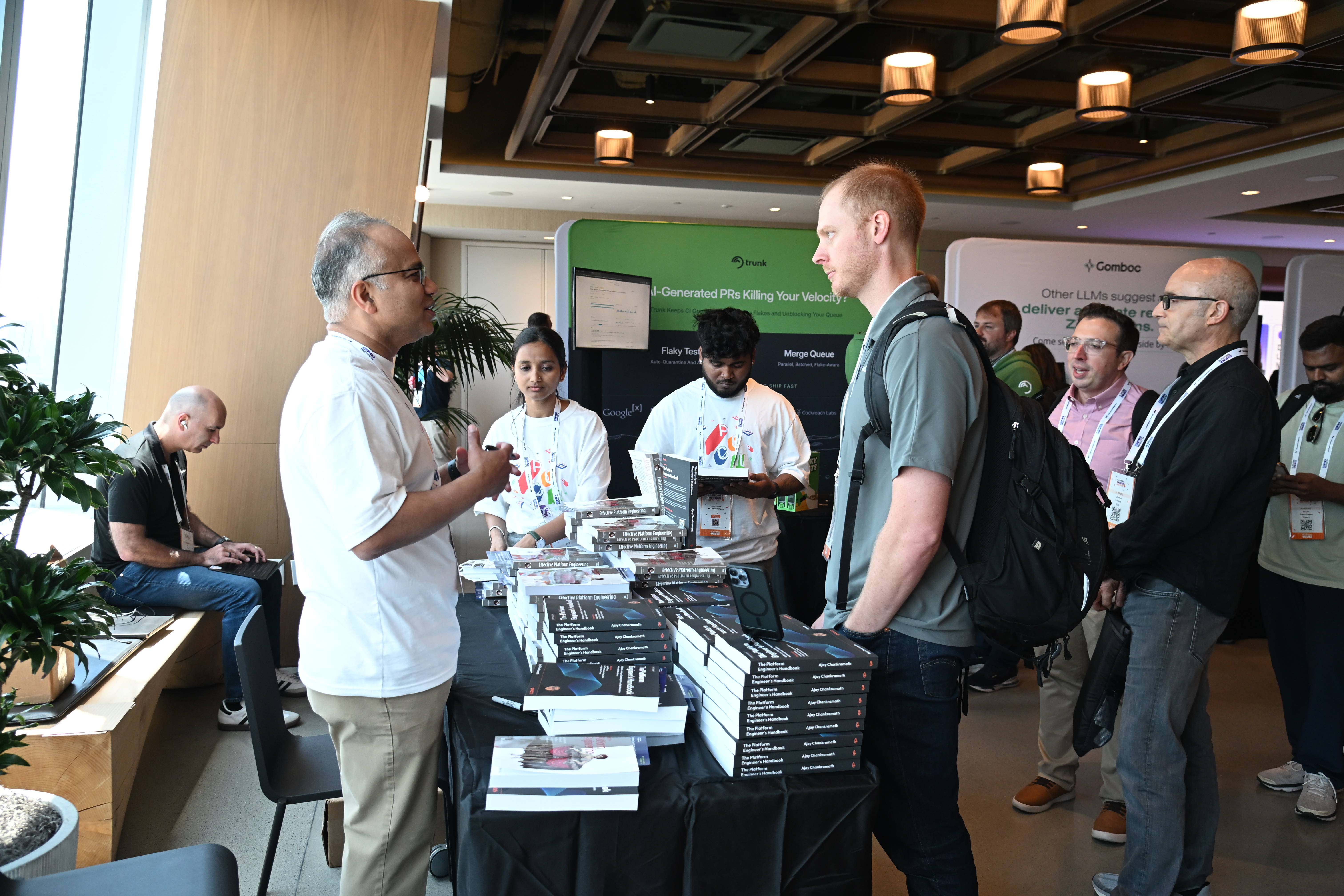 Ajay talking with attendees at the PEC book signing table