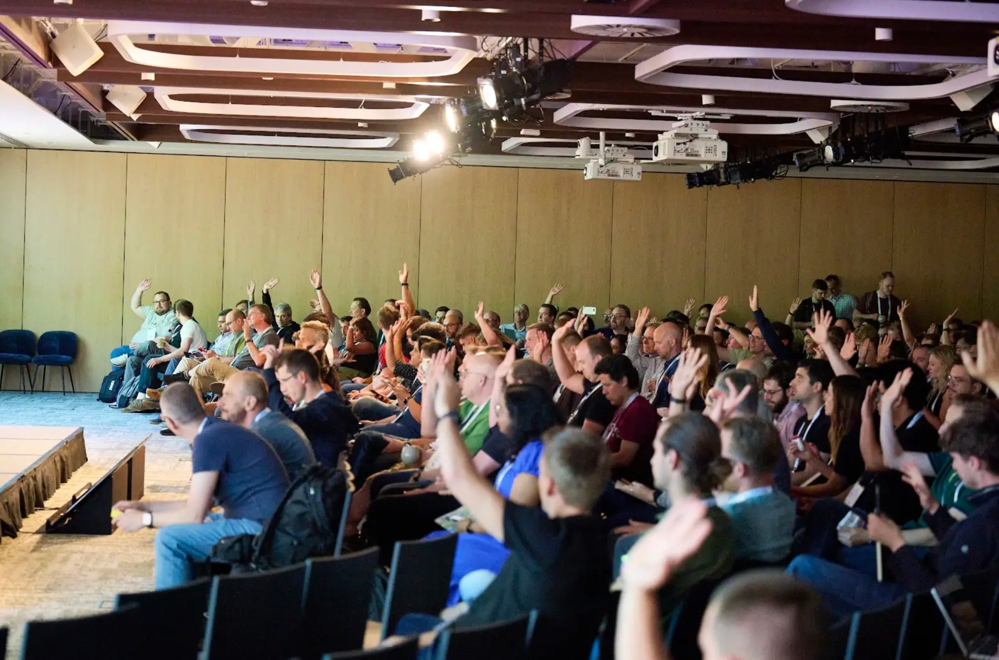 Fiserv platform engineering workshop — audience with hands raised during an interactive session